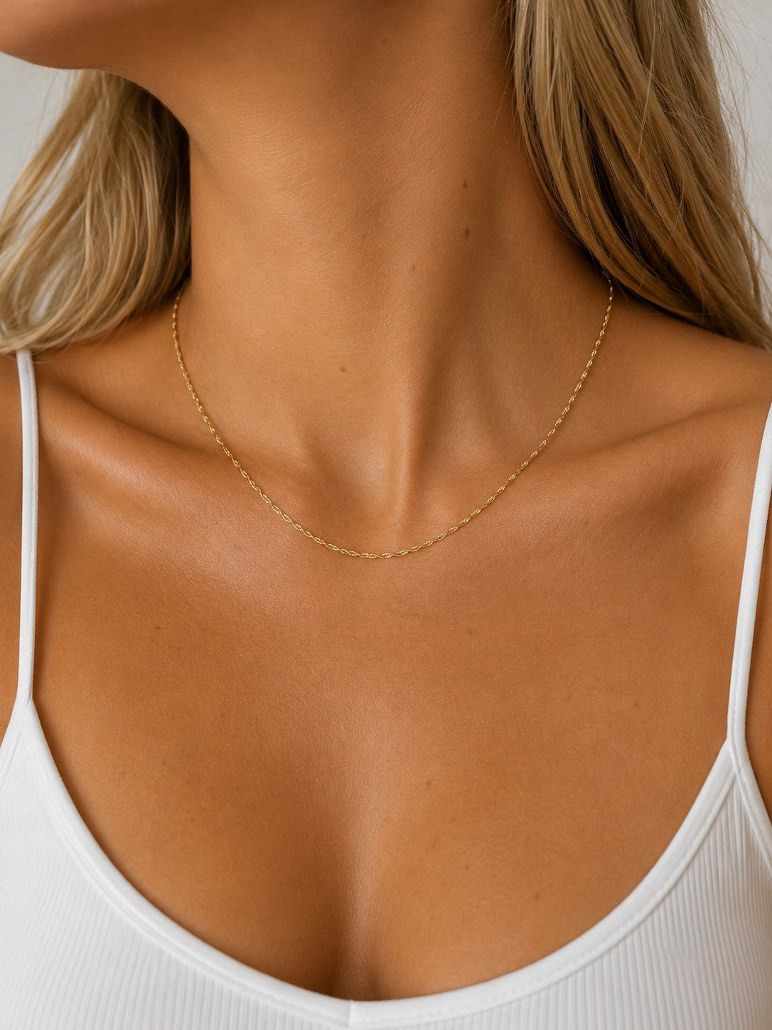 Close-up of the DUGO gold Singapore Chain Necklace worn on the neck