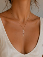 Woman wearing the DUGO gold Snake Ruby Eye Necklace