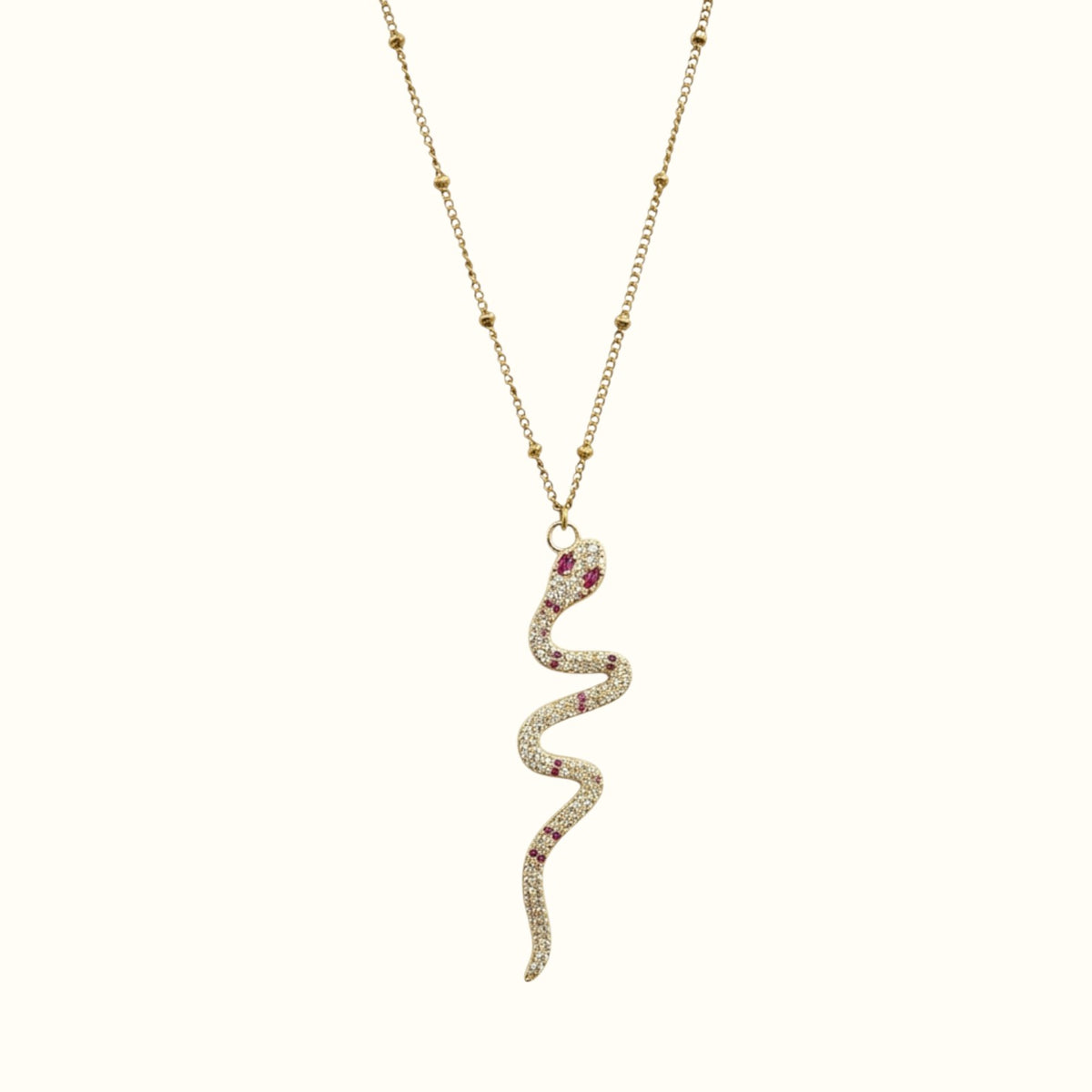 DUGO gold snake pendant necklace with cubic zirconia and ruby red stones on a delicate beaded chain