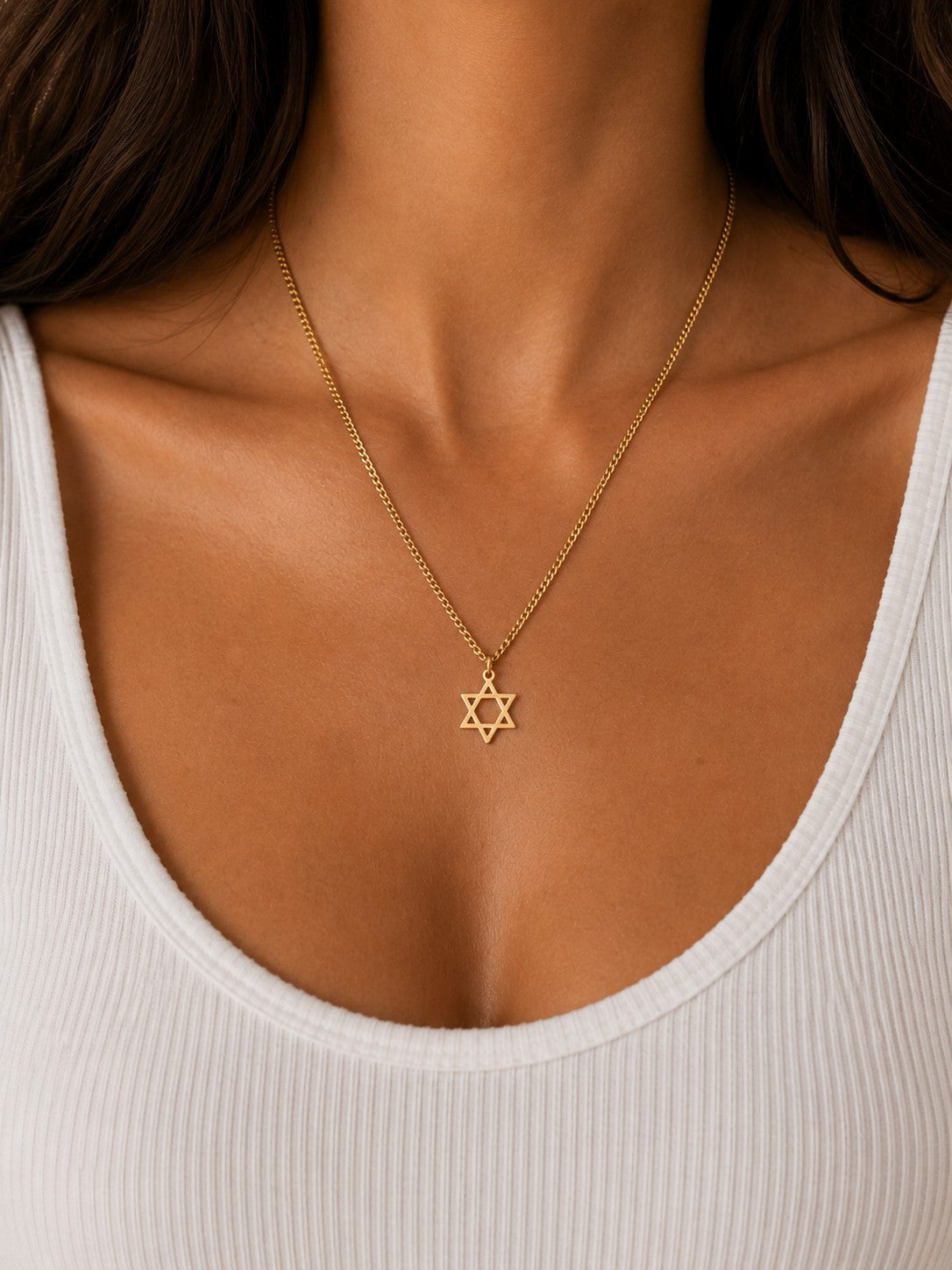 Woman wearing the DUGO gold Star David Classic Necklace