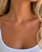 Woman wearing the DUGO gold Star David Classic with Evil Eye Charm Necklace
