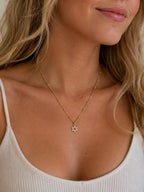 Woman wearing the DUGO gold Star David Necklace