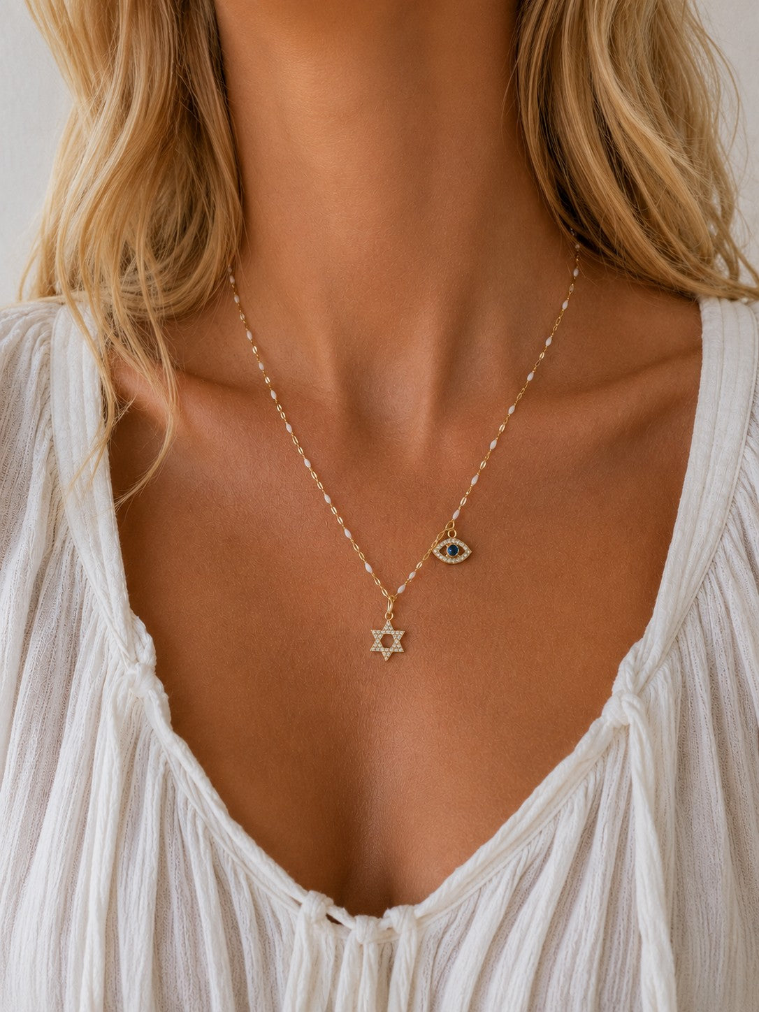 Woman wearing the DUGO gold Star David with Evil Eye Charm Necklace