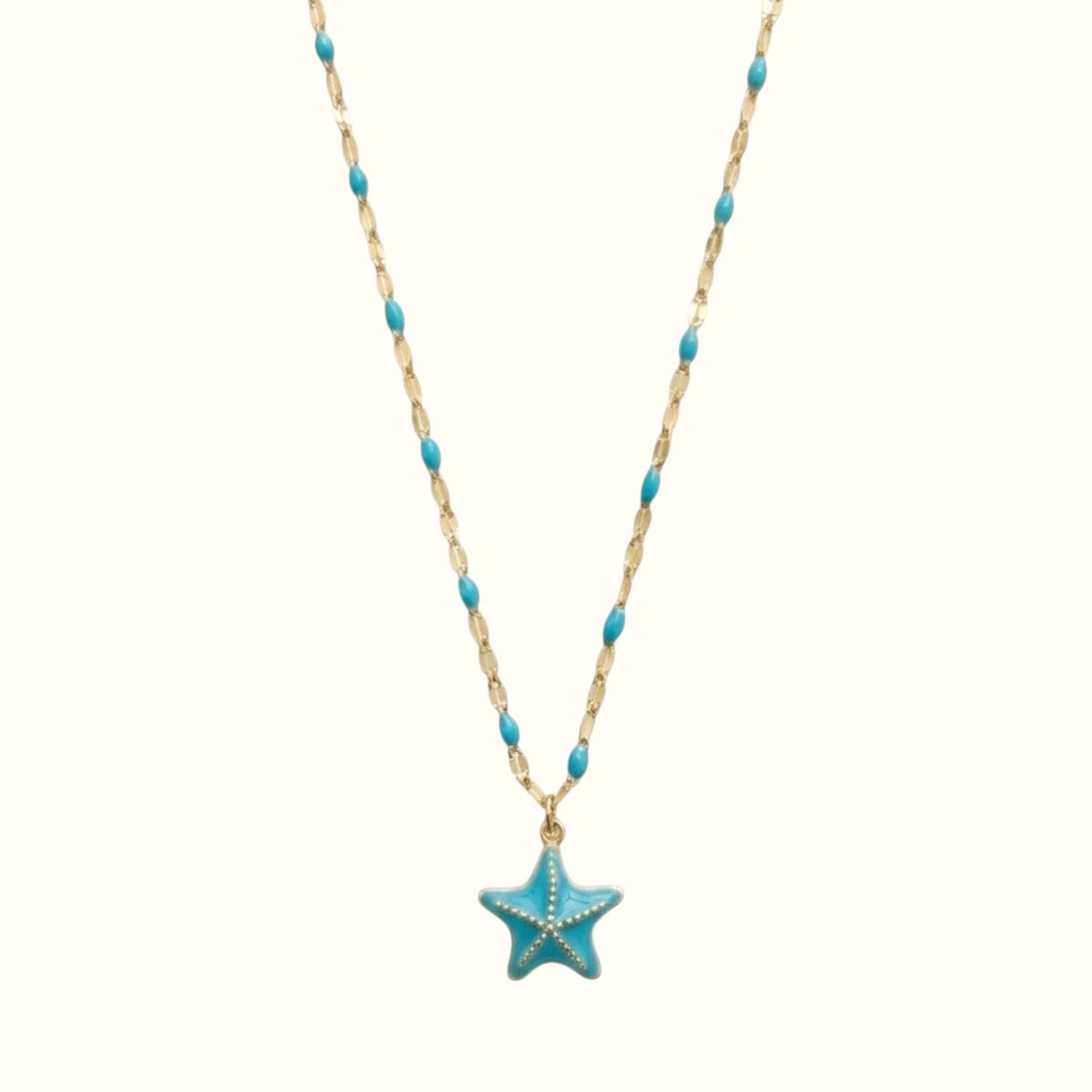DUGO 18K gold-filled necklace featuring a blue enamel starfish pendant and matching turquoise bead chain accents.