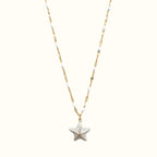 DUGO 18K gold-filled starfish pendant necklace with white enamel beads on a delicate chain for coastal style.