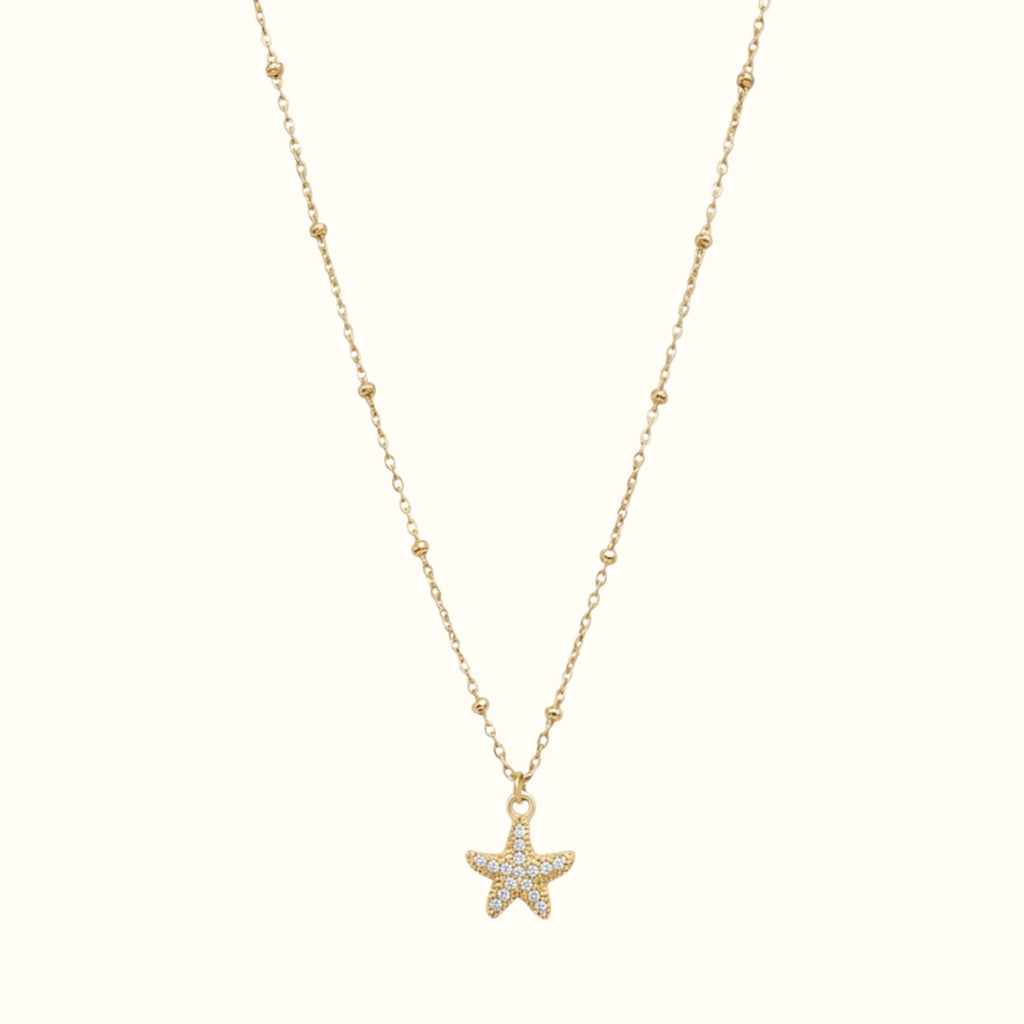 DUGO gold stainless steel starfish necklace with cubic zirconia stones on a delicate beaded chain