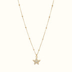 DUGO gold stainless steel starfish necklace with cubic zirconia stones on a delicate beaded chain
