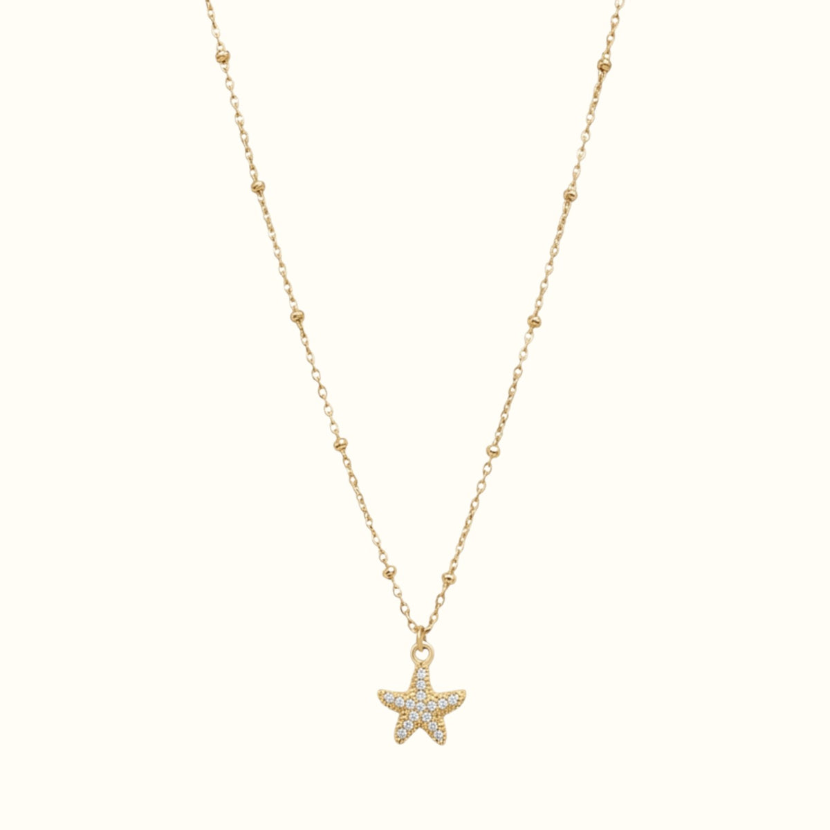 DUGO gold stainless steel starfish necklace with cubic zirconia stones on a delicate beaded chain