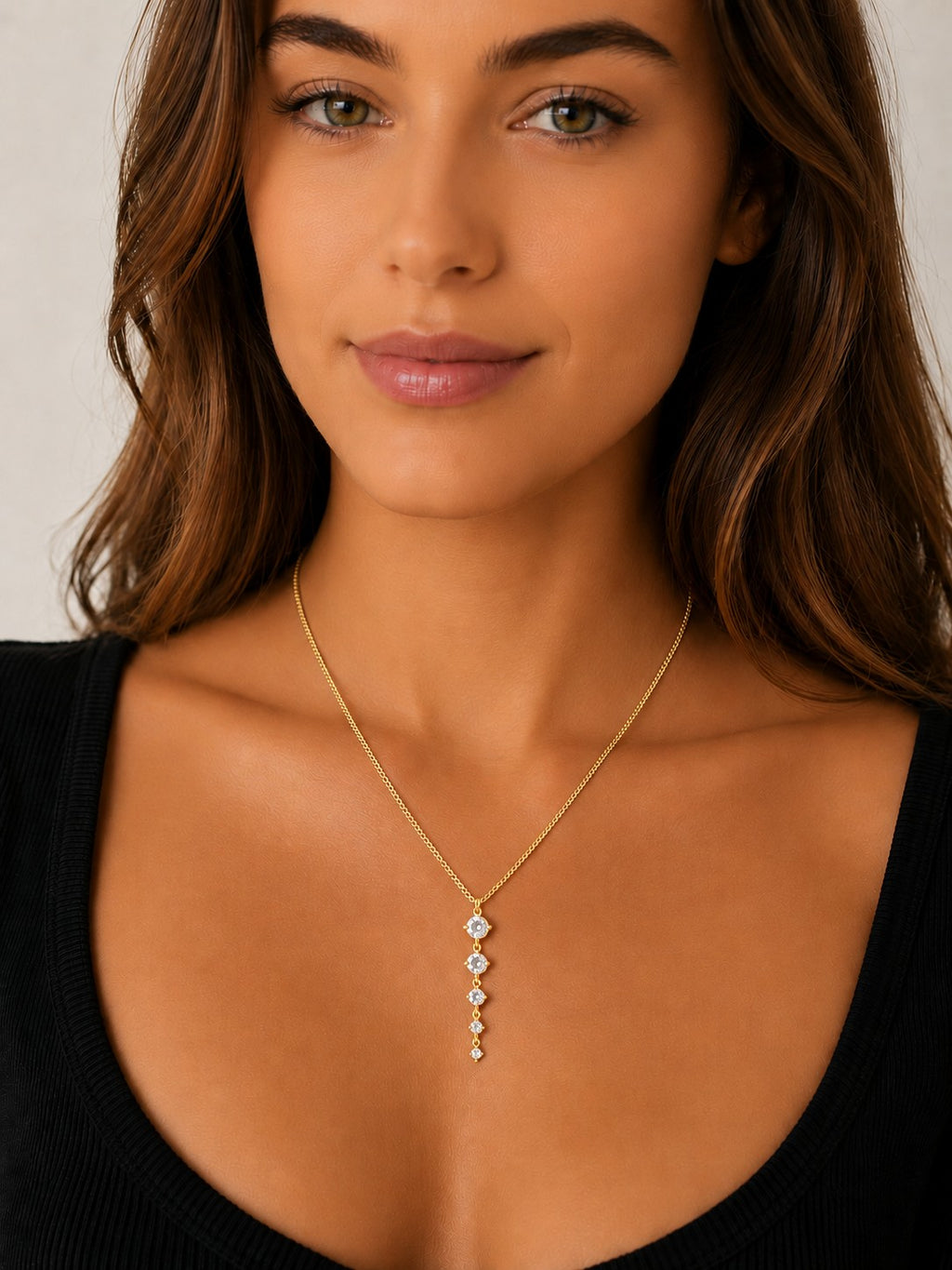 Woman wearing the DUGO gold five links necklace with clear stones on a delicate chain