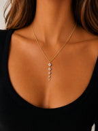 Woman wearing the DUGO gold tennis five links necklace with clear stones