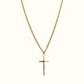 DUGO gold tiny cross pendant necklace on a delicate curb chain against a plain background
