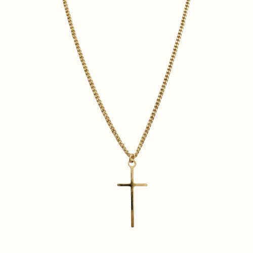 DUGO gold tiny cross pendant necklace on a delicate curb chain against a plain background