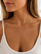 Close-up of the DUGO gold Tiny Heart Chain Necklace worn on the neck