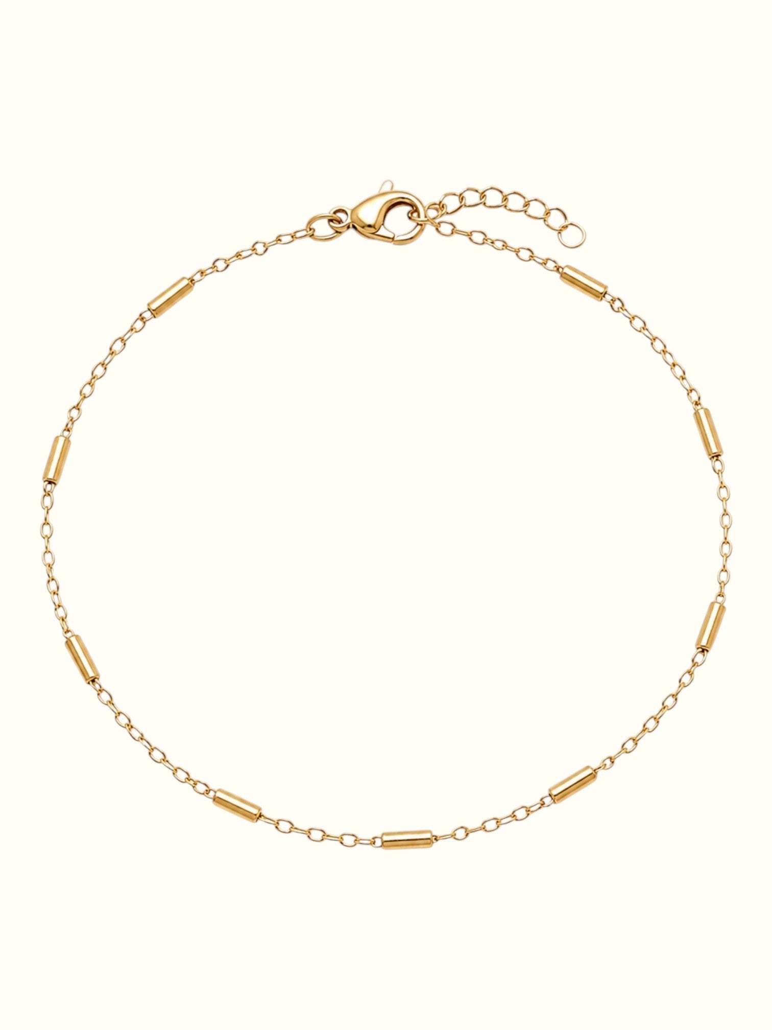 DUGO 18K gold filled minimalist tube station chain bracelet with lobster clasp closure on a light background.