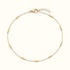 DUGO 18K gold filled minimalist tube station bracelet with a delicate chain and lobster clasp closure.