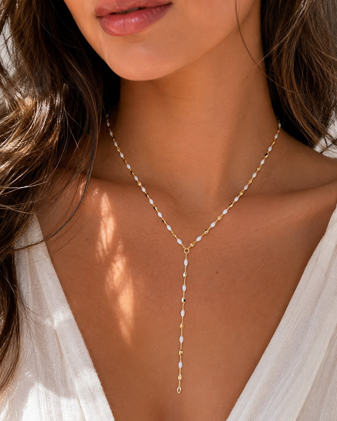 Woman wearing the DUGO gold white Enamel Y Lariat Necklace