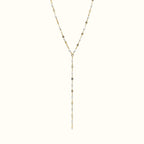 DUGO lariat necklace featuring a delicate gold chain with small white enamel lip-shaped accents in a Y-drop design.