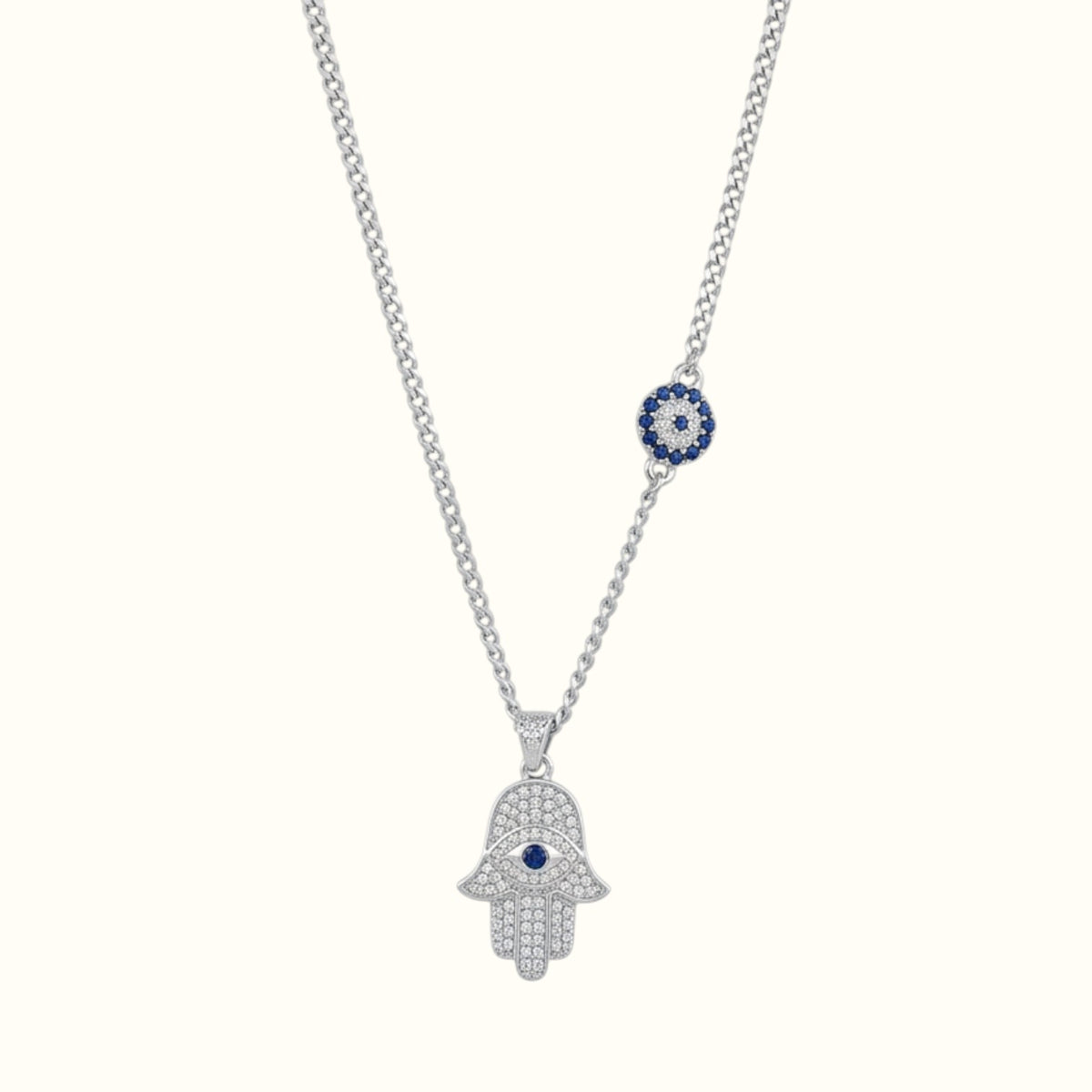 DUGO silver-tone Hamsa hand necklace with cubic zirconia, blue evil eye center, and matching charm on chain.