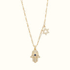 DUGO 18K gold filled Hamsa hand necklace with a blue evil eye, sparkling Star of David charm, and delicate chain.