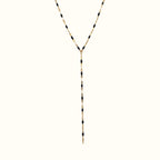 DUGO lariat necklace featuring a delicate gold chain accented with small black beads in a Y-shape design.