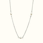 DUGO Pearl Trio necklace featuring three delicate white pearls on a minimalist silver-tone stainless steel chain.