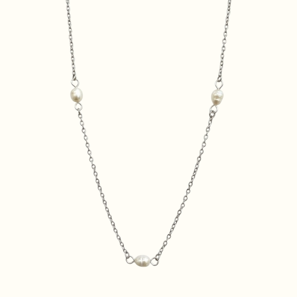 DUGO Pearl Trio necklace featuring three delicate white pearls on a minimalist silver-tone stainless steel chain.