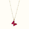 DUGO Butterfly Lover necklace featuring a vibrant pink crystal butterfly pendant on a delicate gold beaded chain