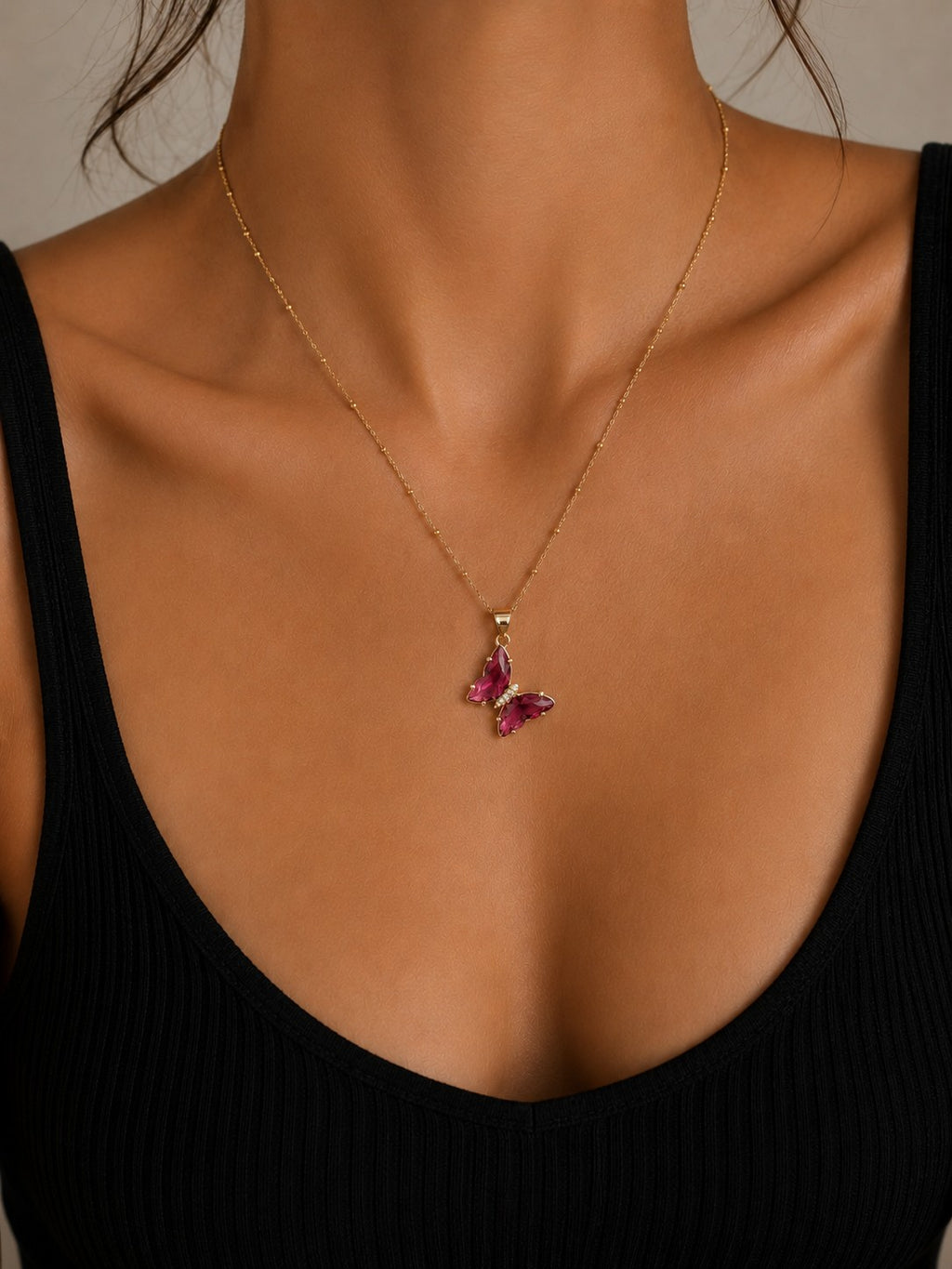 Woman wearing the DUGO pink Butterfly Lover Necklace