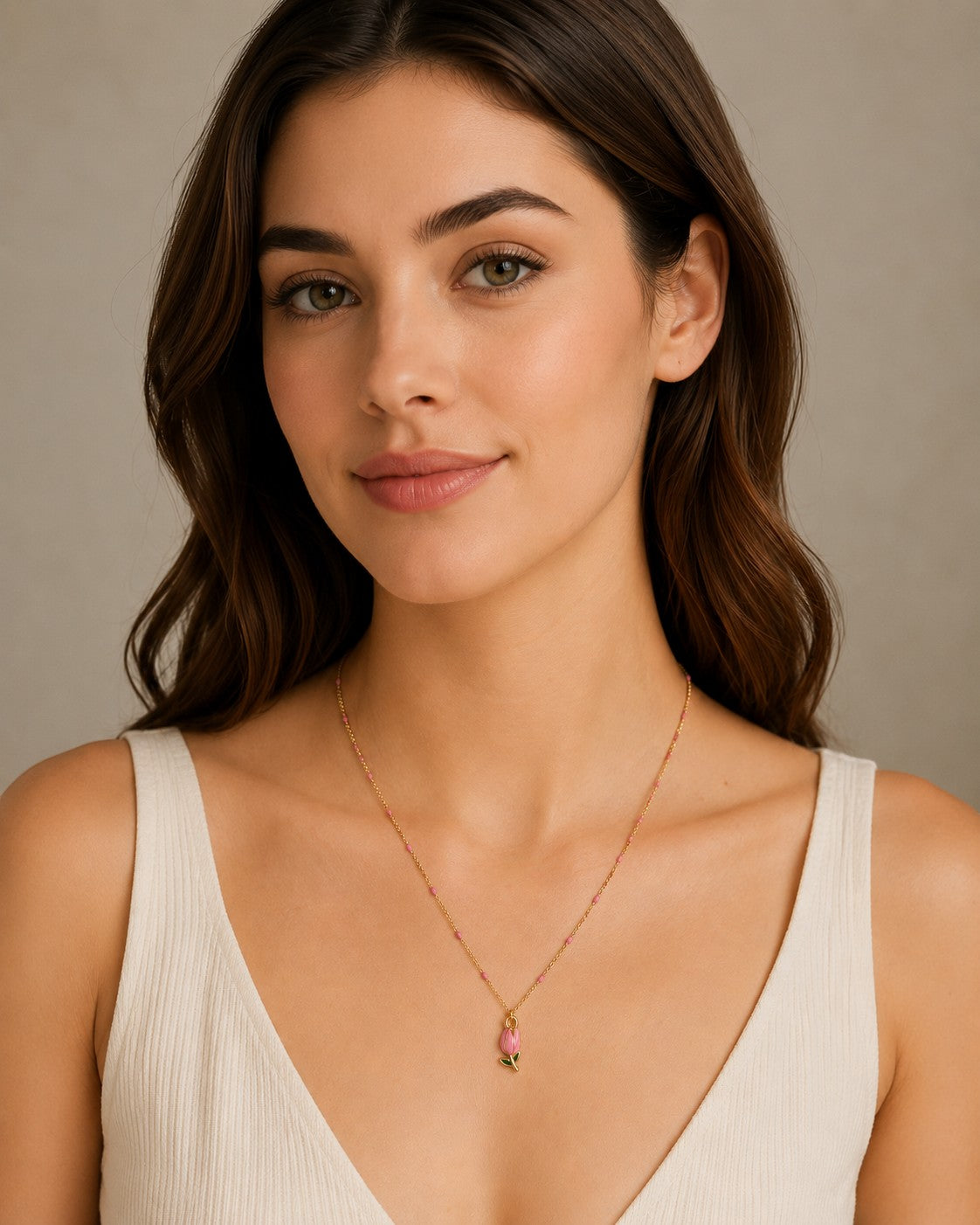 DUGO delicate 18K gold filled necklace featuring a pink tulip pendant and pink bead accents worn by a woman