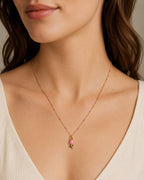 DUGO 18K gold filled necklace featuring a delicate pink tulip pendant and pink enamel accents on a dainty gold chain.