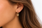 Close-up of DUGO gold Puffy Heart Hoop Earring