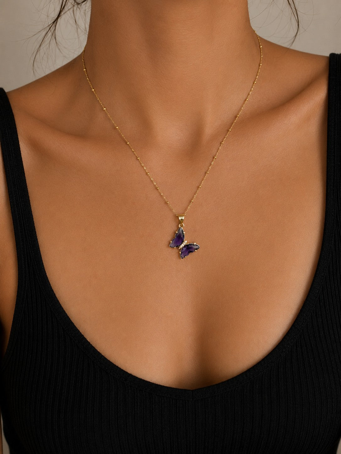 Woman wearing the DUGO purple Butterfly Lover Necklace