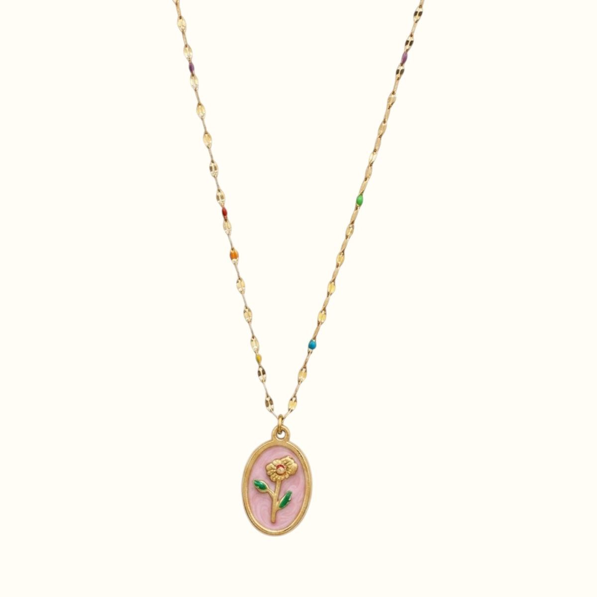 DUGO rose pink necklace featuring an oval pendant with a gold flower design on a delicate multi-colored beaded chain.