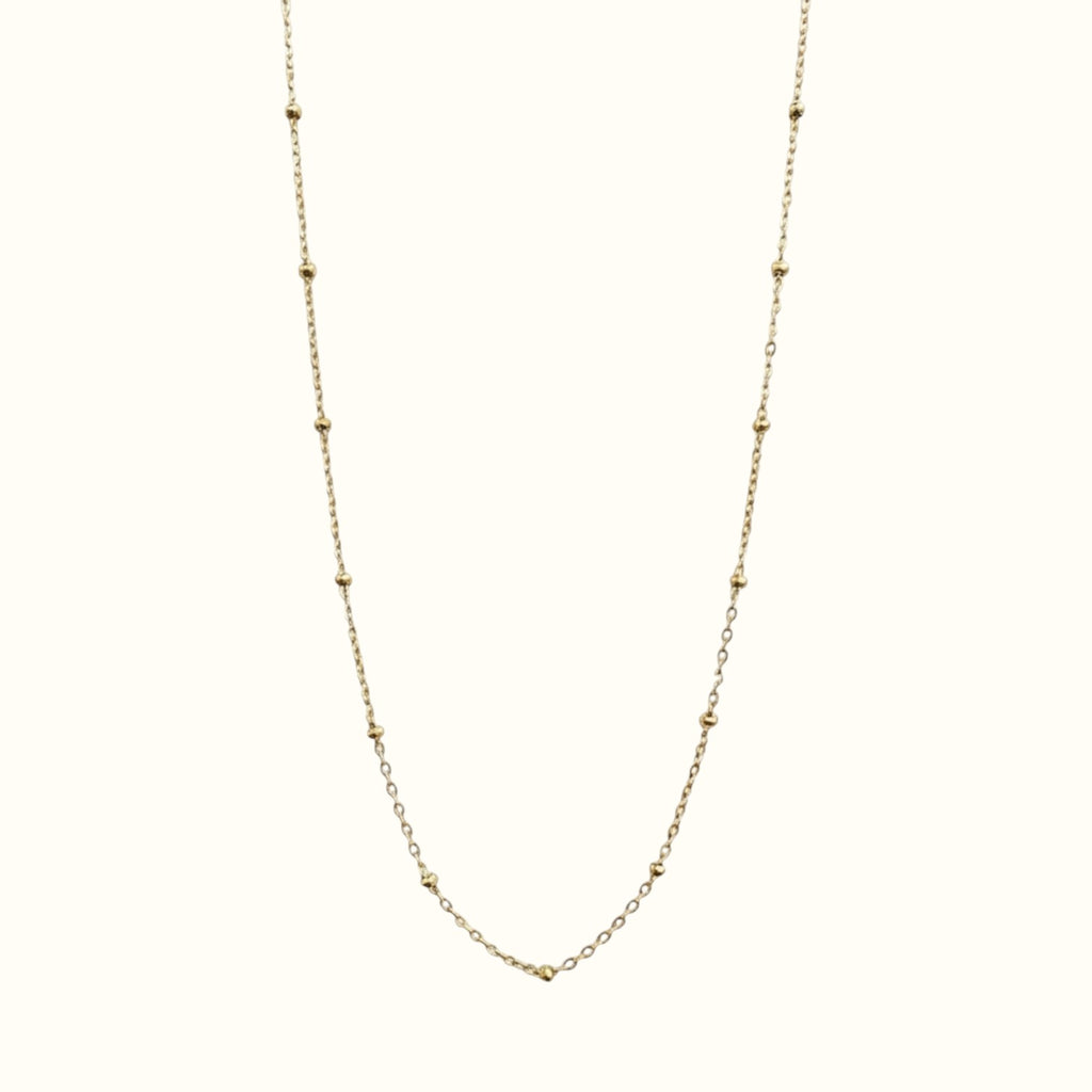 DUGO minimalist satellite bead necklace in 18K gold filled, featuring a dainty cable chain with evenly spaced beads.