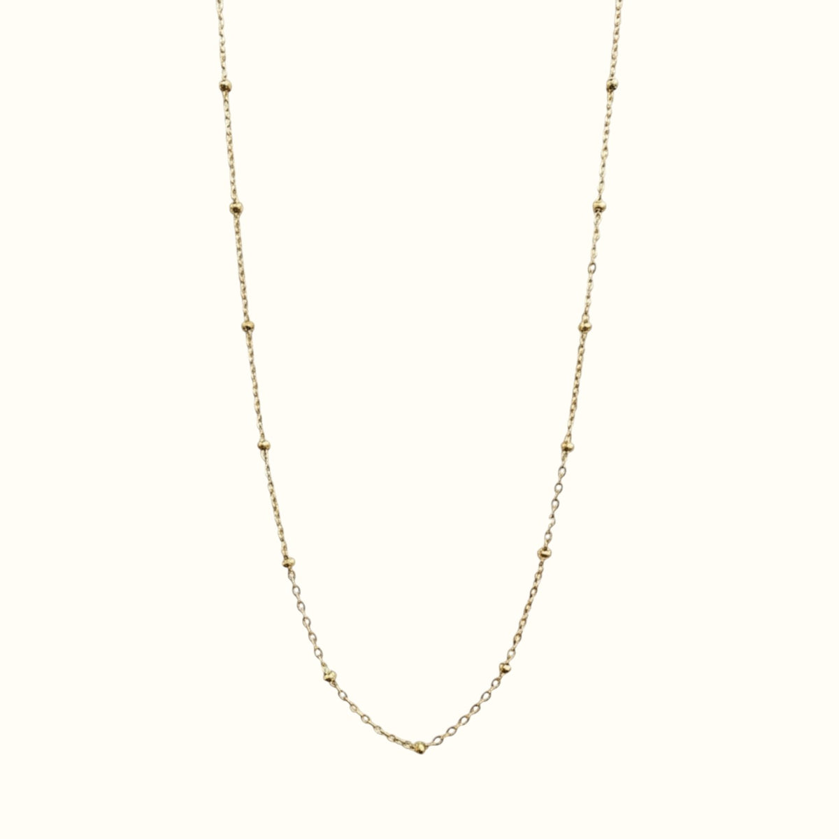 DUGO minimalist satellite bead necklace in 18K gold filled, featuring a dainty cable chain with evenly spaced beads.