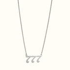 DUGO silver-tone Lucky Number 777 pendant necklace on a delicate curb chain against a light background