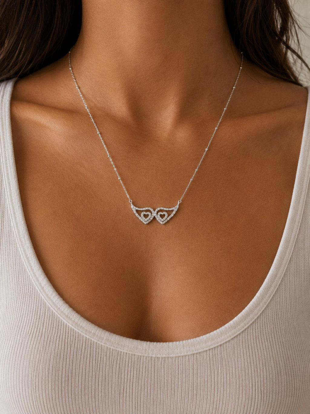 Woman wearing the DUGO silver Angel Wings Zirconia Necklace