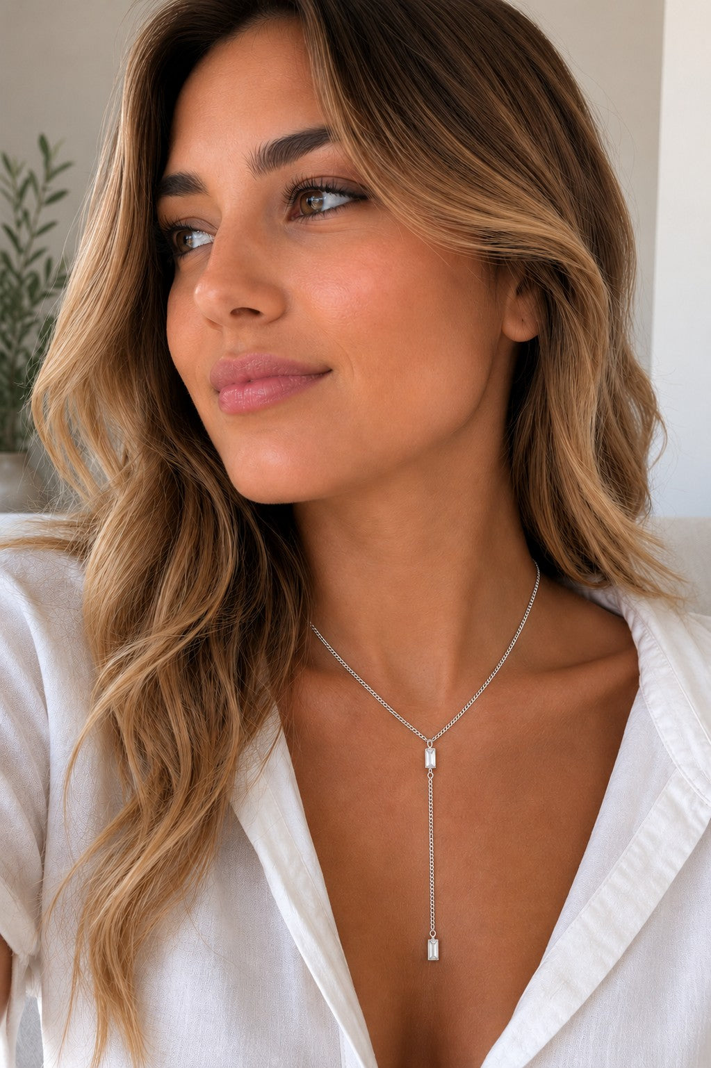 Close-up of the DUGO silver Baguette Crystal Y Lariat Necklace worn on the neck