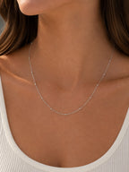 Close-up of the DUGO silver Ball Cable Chain Satellite Bead Necklace worn on the neck