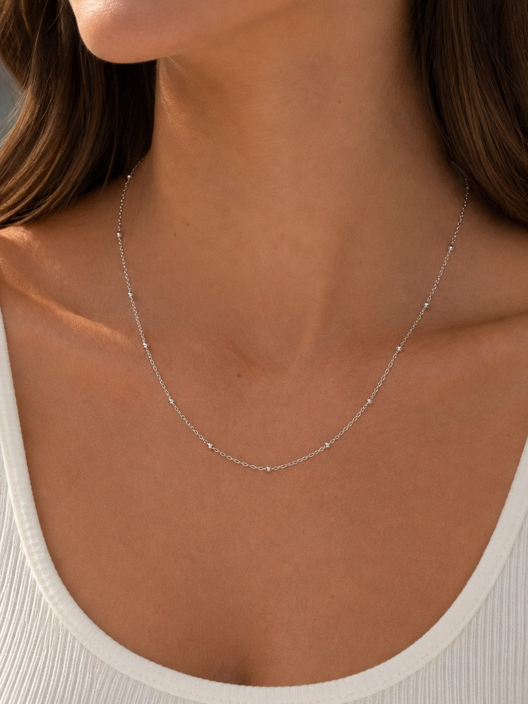 Close-up of the DUGO silver Ball Cable Chain Satellite Bead Necklace worn on the neck
