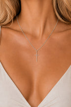 Woman wearing the DUGO silver Cross Tiny Necklace