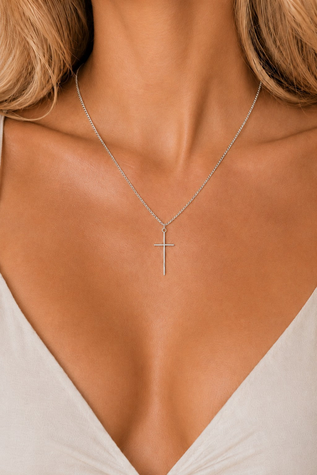 Woman wearing the DUGO silver Cross Tiny Necklace
