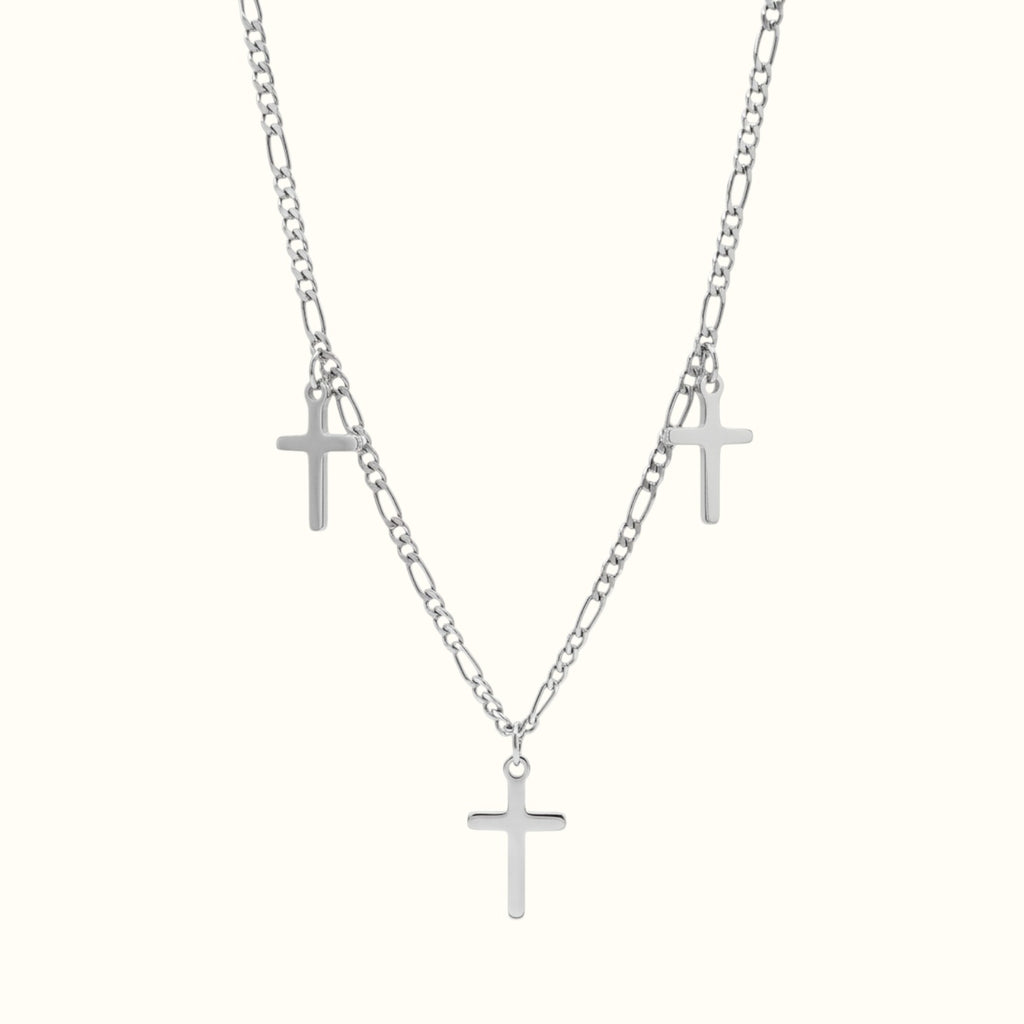 DUGO Cross Trio necklace featuring three silver-toned cross pendants on a delicate figaro chain