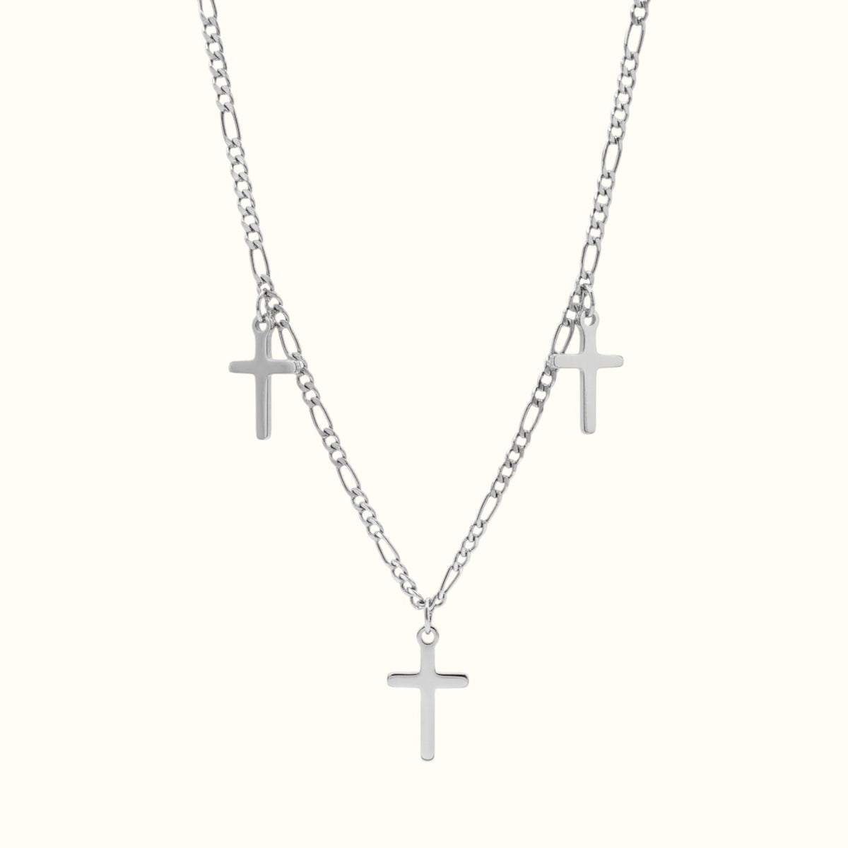 DUGO Cross Trio necklace featuring three silver-toned cross pendants on a delicate figaro chain