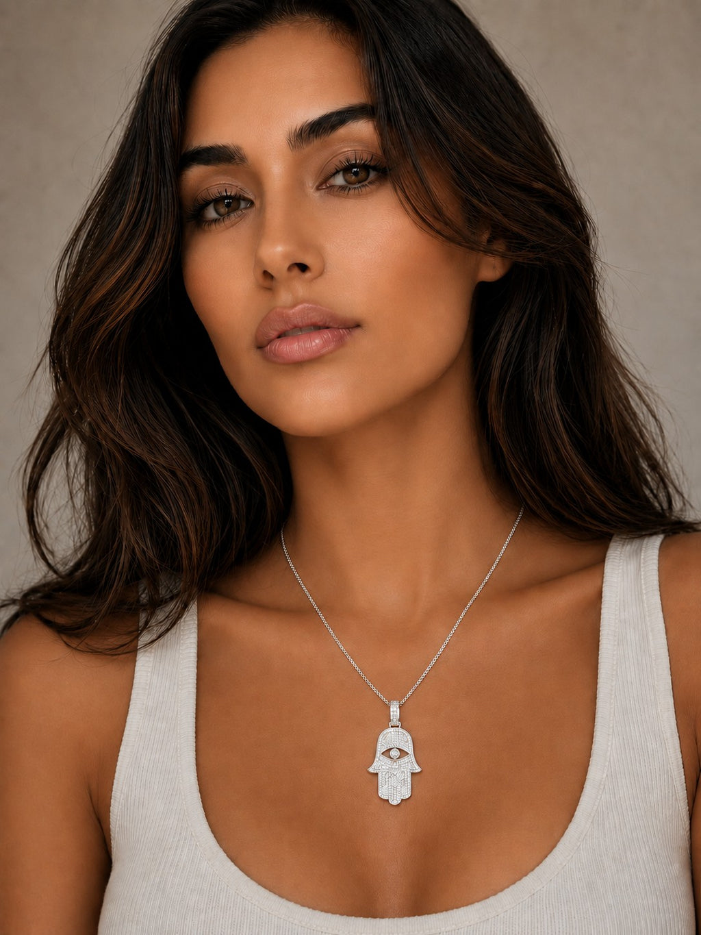 Close-up of the DUGO silver Hamsa Large Necklace worn on the neck