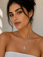 Close-up of the DUGO silver Hamsa with Star David Charm Necklace worn on the neck