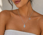 Woman wearing the DUGO silver Hamsa with Star David Charm Necklace