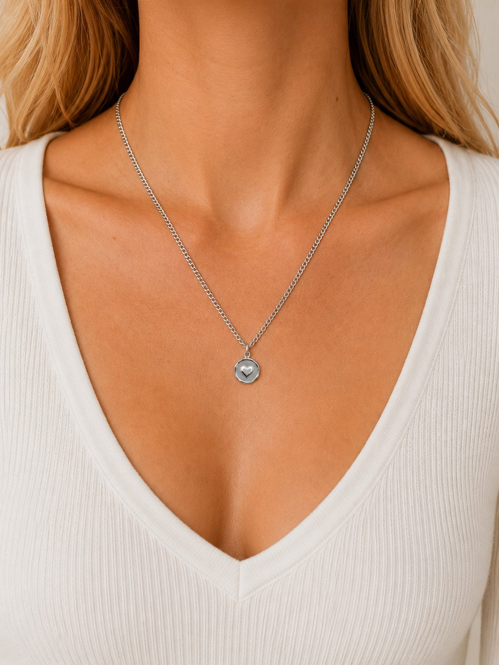 Woman wearing the DUGO silver Heart Coin Necklace