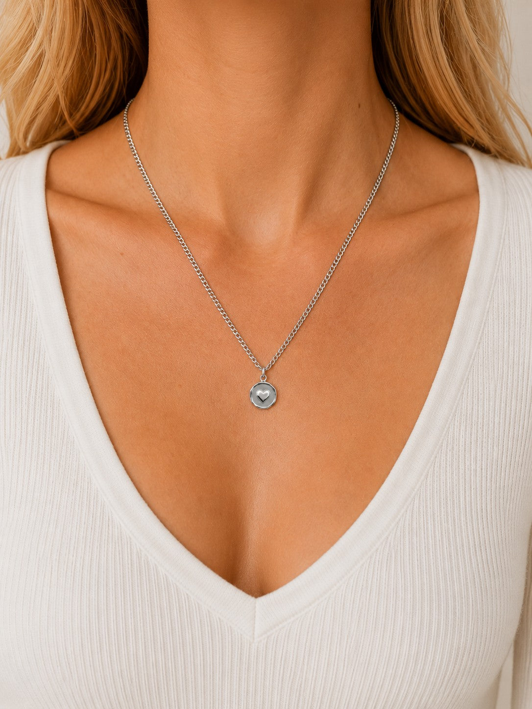 Woman wearing the DUGO silver Heart Coin Necklace