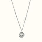 DUGO silver heart plate necklace featuring a small raised heart charm on a delicate circular pendant and chain